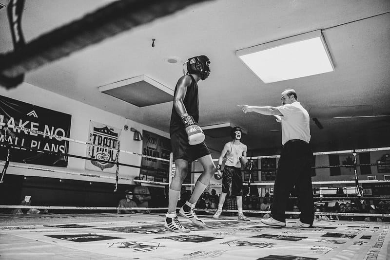 Referee sending a boxer to a neutral corner during a standing 8 count